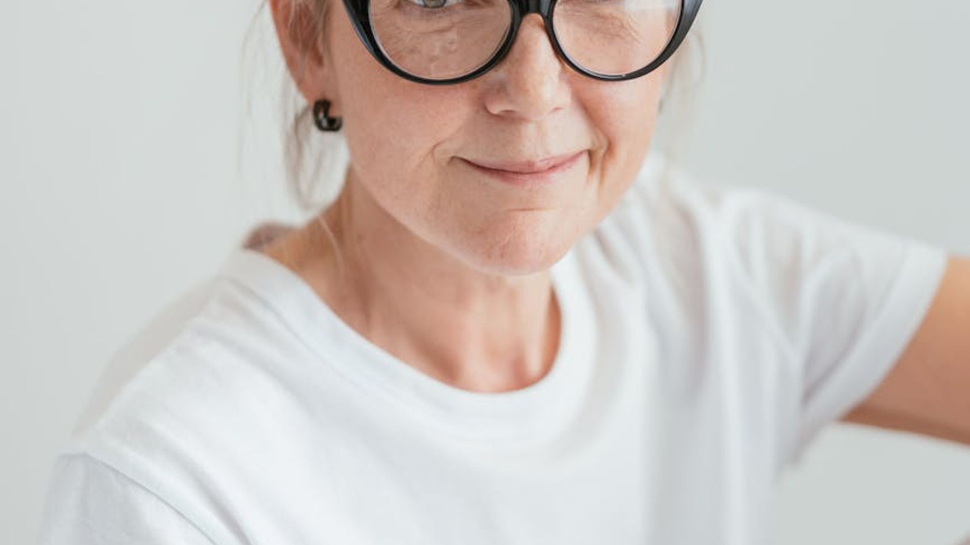 Person moving gracefully in a bright spacious studio environment.